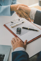 Insurance officers hand over the car keys after the tenant. have signed an auto insurance document...