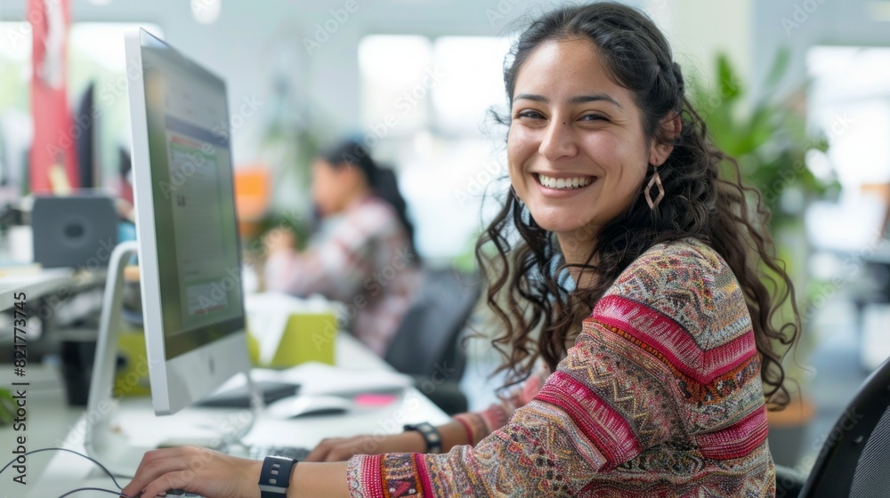 Poster a woman is smiling and sitting in front of a computer