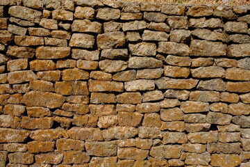 natural stone wall. box-shaped natural stone stacked into a natural stone wall. limestone, andesite, marble is often used for natural stone walls. good architectural element.