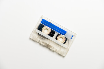 Audio cassette with black tape on a white background, top view. Template for inscription