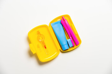 Oral care.Travel set with a toothbrush, toothbrush and toothpaste in a case. Dentist concept. Flat lay, copy space