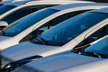 Row of white cars on a parking lot.