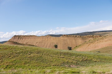 Obraz premium Panorama of beautiful countryside of Georgia. Sunny afternoon. Wonderful landscape in mountains. Grassy field and hills