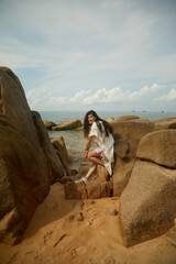 woman sitting on the rocks