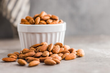 Peeled almond nuts on kitchen table.