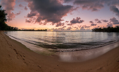 Hawaiian Kawela Bay Beach colorful Sunset Phase with silhouette palm trees
