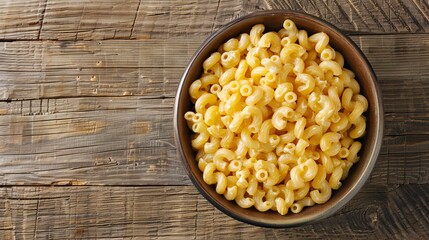 Cheesy macaroni in a bowl, captured from above on a wooden table