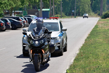 A police officer confidently rides a motorcycle down a bustling street, blending in seamlessly with the flow of traffic, keeping a watchful eye on their surroundings