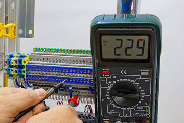 Measurement of electrical circuit parameters using a multimeter in an electrical switchboard.	
