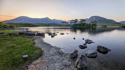 Lakeside landscape sunset scenery of Twelve pines island, Derryclare lake at Connemara, Galway Ireland, nature background