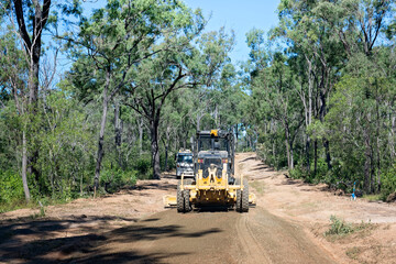 Obraz premium grader grading machinery rural dirt road, Australian gum tree eucalypt forest, industry industrial roadwork maintenance repair, public access transport distance isolation