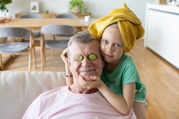 Grandfather and granddaughter doing skin care at home