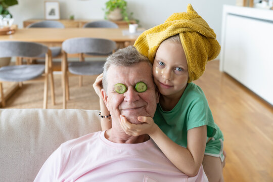 Grandfather and granddaughter doing skin care at home - Powered by Adobe