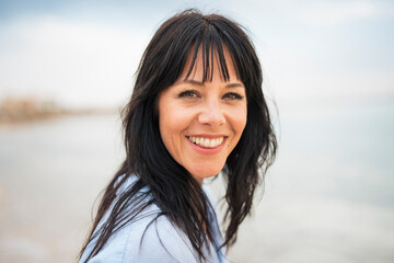 Happy woman with toothy smile at beach