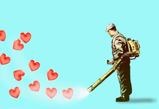Man blowing away hearts using leaf blower against blue background