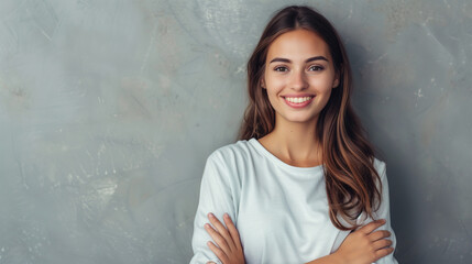 A confident woman stands with her arms crossed, radiating joy and positivity with a bright smile on her face.