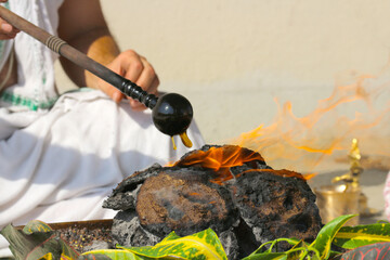 Brahman pours oil on the fire. Yagya or havan or homa is a Hindu religious fire ritual.