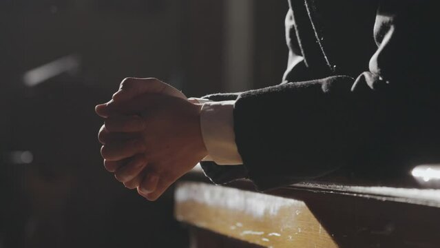 Cinematic Tracking Priest's Hands Clasped In Prayer. 