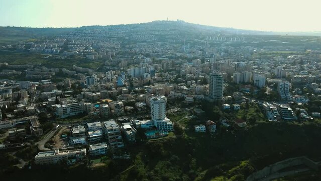 Drone shot of tiberias city.
The city of Lower Tiberias is close to the Sea of Galilee.
You can see the hotels and the city spread out on the side of the mountain.