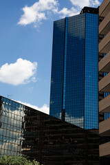 Reflective skyscrapers in Naples daytime clouds