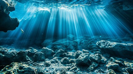 Obraz premium Underwater view of a deep sea canyon with rocks and sun rays through the water surface