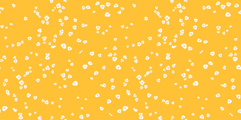 Simple yellow seamless pattern with abstract tiny flowers, polka dots, scattered randomly dots, spots, drops. Vector hand drawing sketch shapes. Painted ditsy floral printing. Template for designs