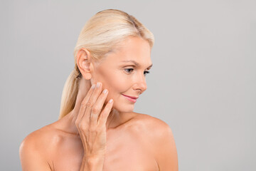 Photo of attractive dreamy healthy gentle lady touching skin apply anti age lotion tonic look empty...