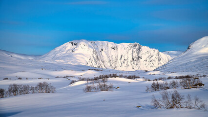 Norwegian high mountains in the snow. Mountains covered with snow. Scandinavia