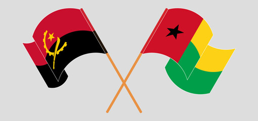 Crossed and waving flags of Angola and Guinea-Bissau