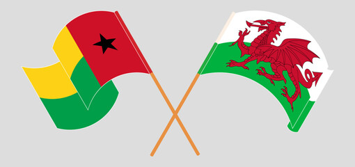 Crossed and waving flags of Guinea-Bissau and Wales