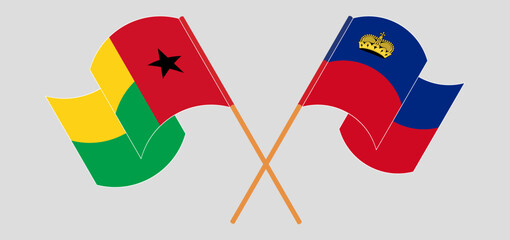 Crossed and waving flags of Guinea-Bissau and Liechtenstein