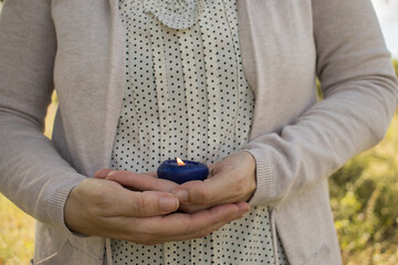 hands woman holding blue candle. Meditation. Relaxation. aromatherapy. concept. Horizontal