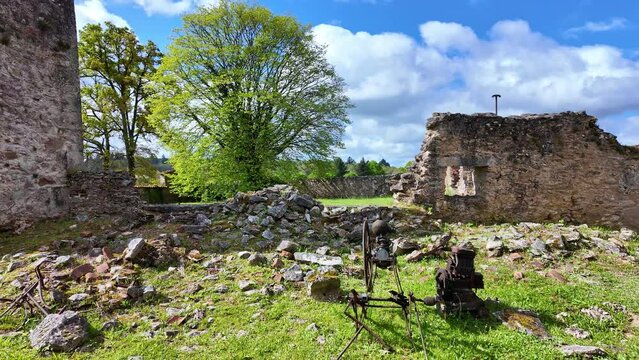 Ancient objects among ruins of  Oradour-sur-Glane ghost village, Haute-Vienne department, New Aquitaine in France. Sideways shot