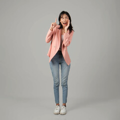 full lenght shoot of happy asian woman shouting with cupping hand and pointing finger wearing formal casual outfit on isolated background © Ibenk.88