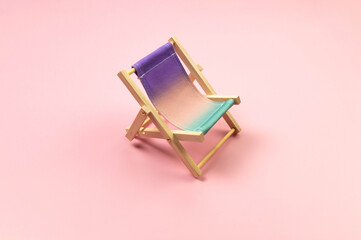 Colorful beach chair on pink background. Summer, holidays and beach concept. Creative composition,...