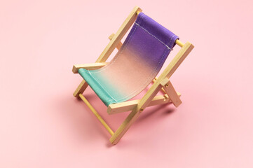 Colorful beach chair on pink background. Summer, holidays and beach concept. Creative composition,...