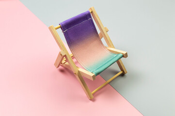 Colorful beach chair on colorful background. Summer, holidays and beach concept. Creative...