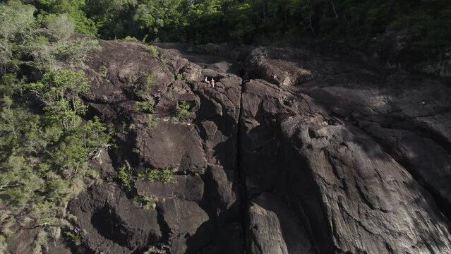 Aerial view of lush greenery and rocky cliffs in remote Tully Gorge National Park, Queensland, Australia.