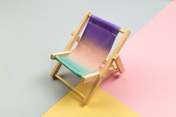 Colorful beach chair on colorful background. Summer, holidays and beach concept. Creative...