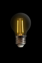 Portrait of light bulb lit on black background. Inspiration, glowing, imagination and solution concept.