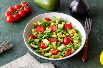 Salad with avocado, tomatoes and corn. Healthy eating. Vegetarian food.