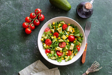 Salad with avocado, tomatoes and corn. Healthy eating. Vegetarian food.