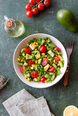 Salad with avocado, tomatoes and corn. Healthy eating. Vegetarian food.