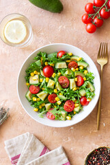Salad with avocado, tomatoes and corn. Healthy eating. Vegetarian food.