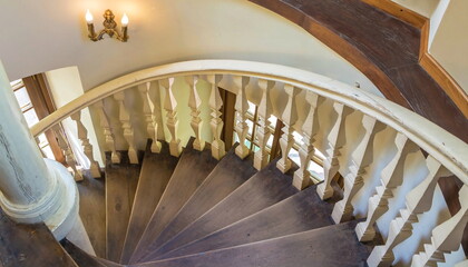 Antique wooden staircase with carved handrails