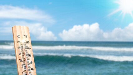 Thermometer with hot temperature on the beach