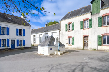 Locmaria in Belle-Ile, Brittany, typical street in the village, a fountain in the center
