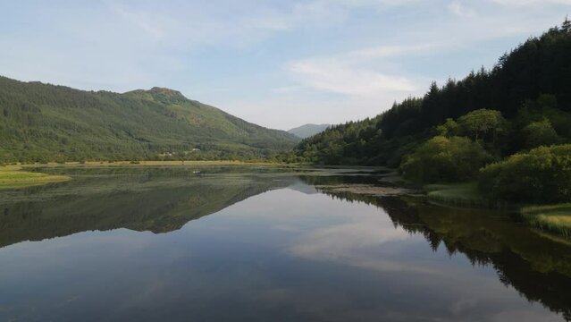 Aerial view of Loch Lubnaig surrounded by serene mountains and lush forest, Highlands, United Kingdom.