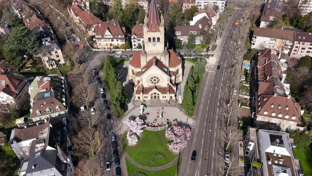 Basel's st. paulus church with blooming magnolia trees in spring, aerial view