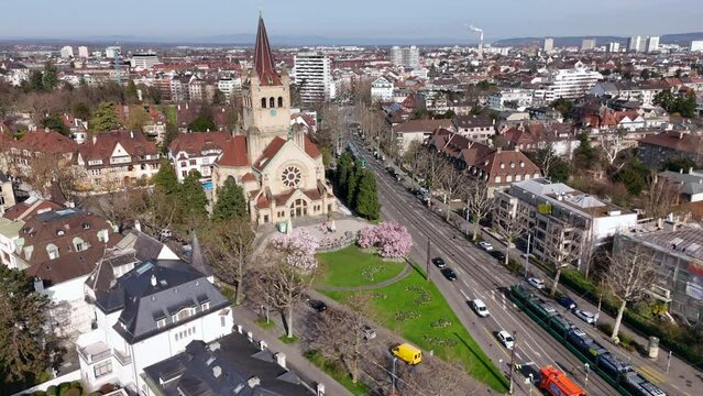 Basel's st. paulus church with magnolia blossoms and cityscape in spring, aerial view